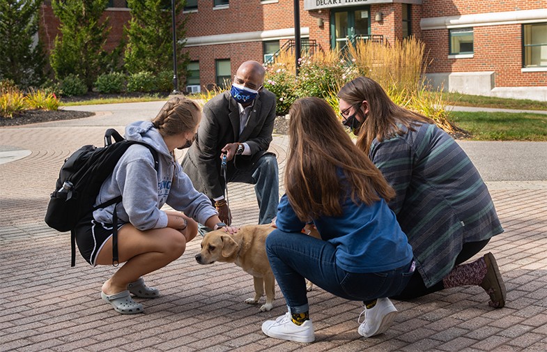 chris hunt with students and his dog