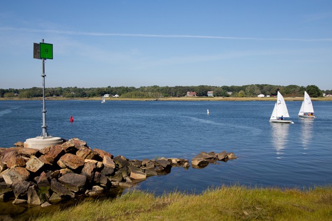 coast on the biddeford campus with two sailboats in the water