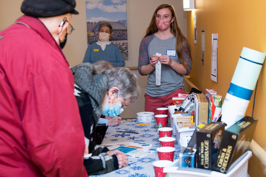 Student Hannah Jones helps residents with raffle tickets 