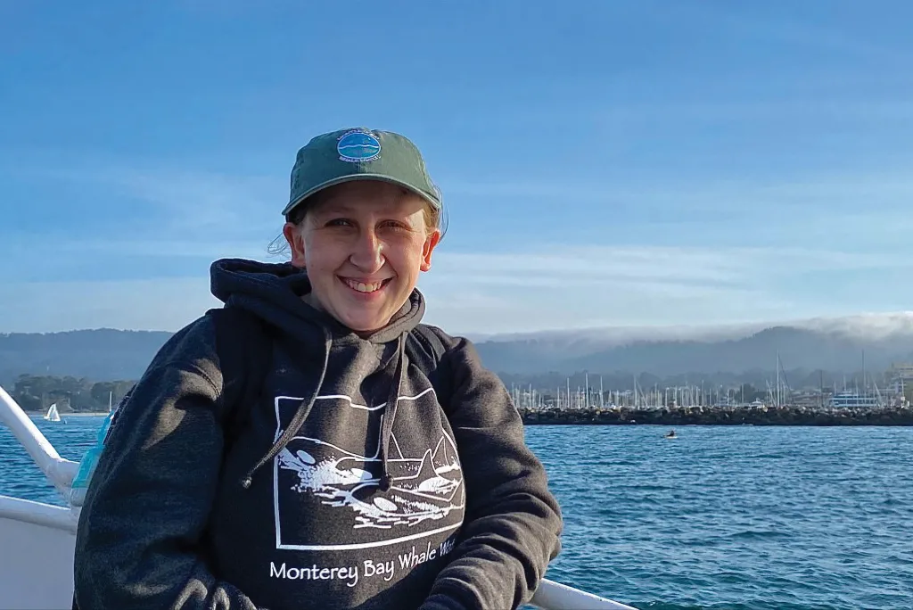 Photo of U N E student Morgan Quimby in front of the ocean