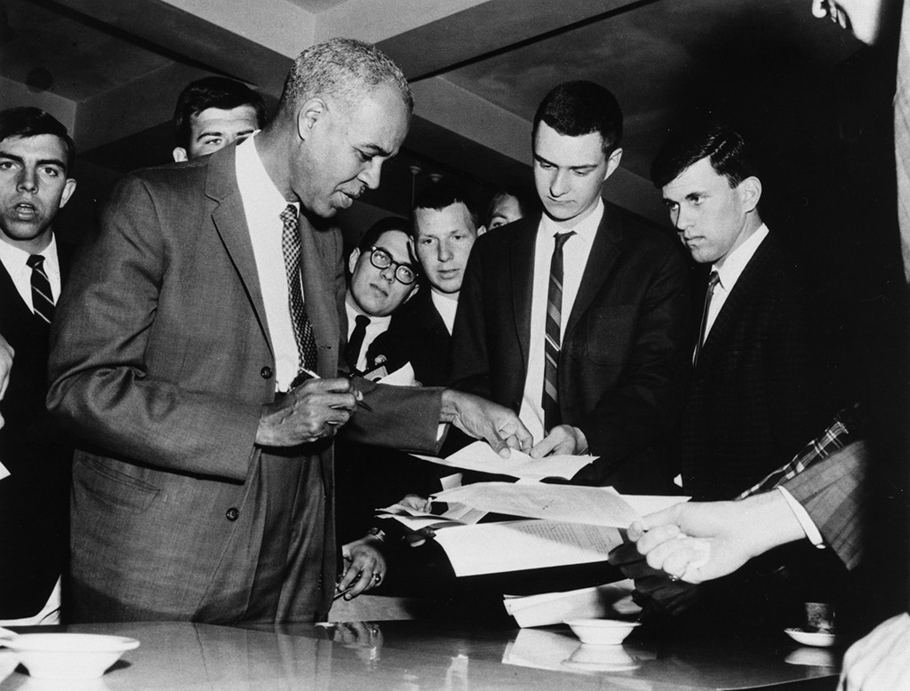 Roy Wilkins signing autographs