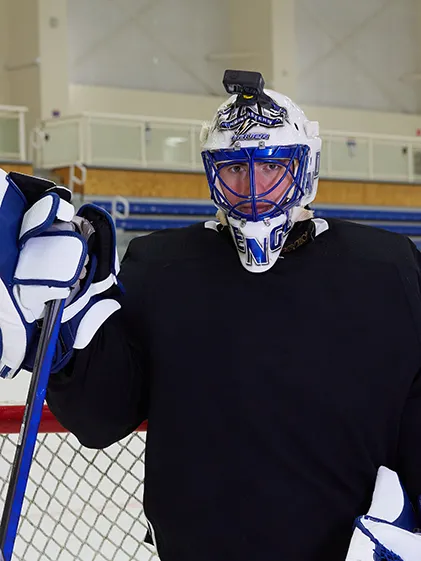 Patrick Schena in his hockey goalie uniform on the UNE ice rink