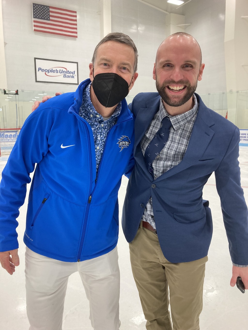 President Herbert poses with men's ice hockey head coach Kevin Swallow