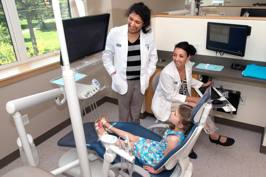Dental students prepare a child patient for their appointment at the Oral Health Center