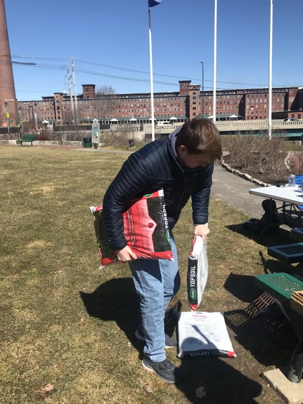 Student with packages of soil