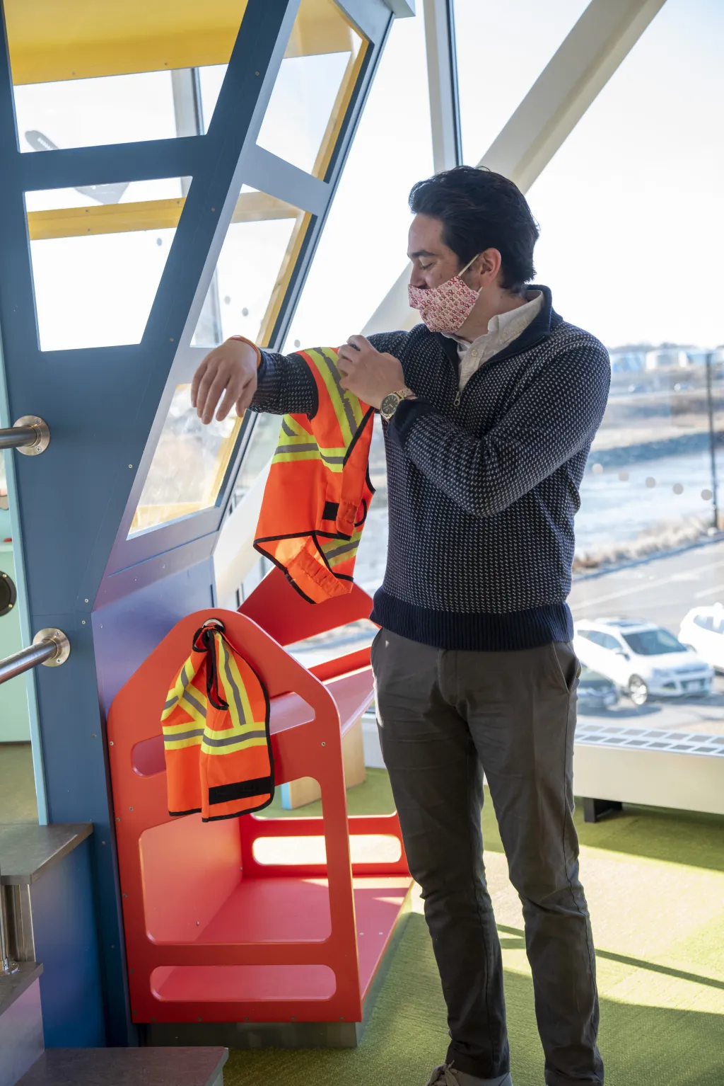 Nate Pickett tries on a kid-sized air traffic control vest 