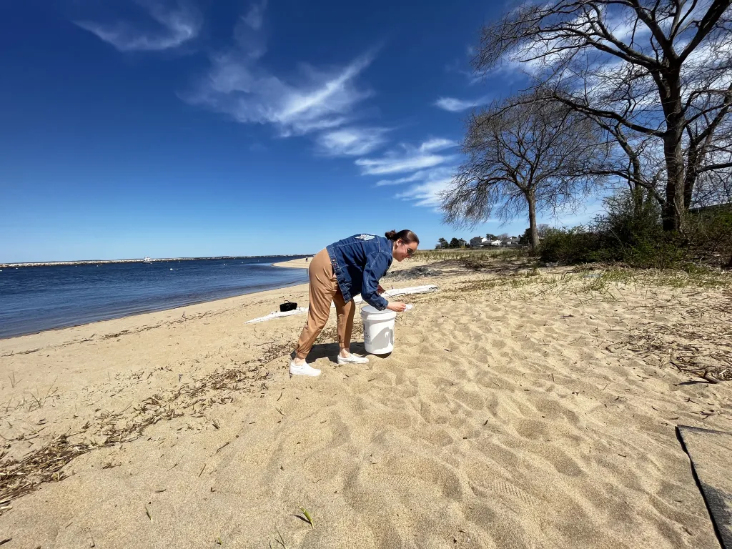 Jasmine Bouchard picks up litter from Freddy Beach on May 5