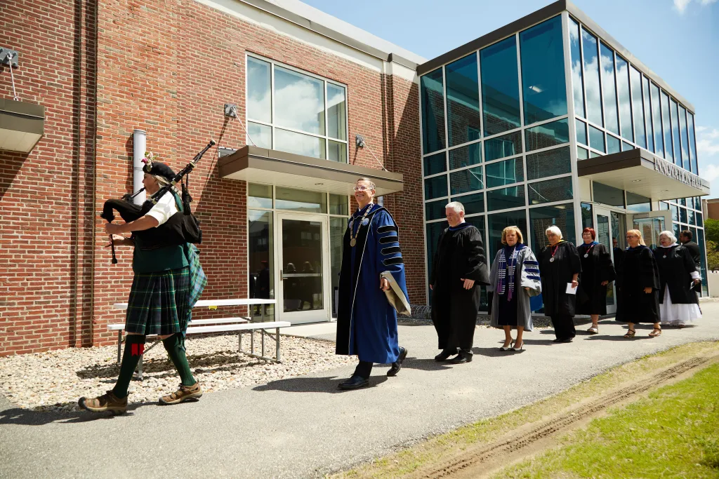 The stage party processes into the ceremony.