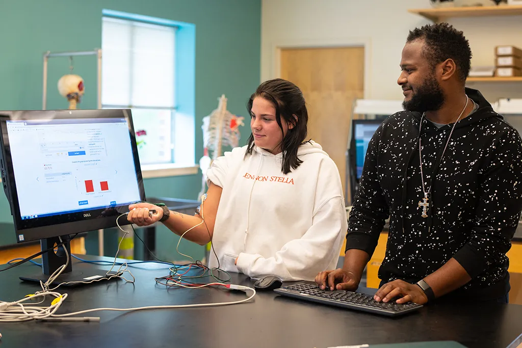 Two students testing technology in the biology lab