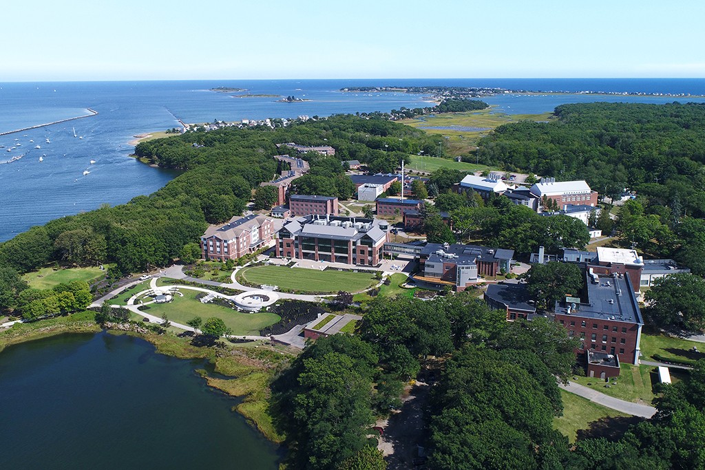 An aerial view of the Biddeford Campus near the river and ocean