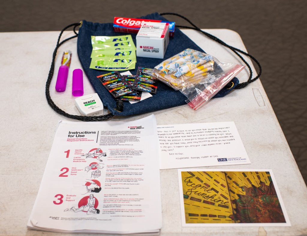An assortment of items to go in the harm reduction kits, including toothbrushes, toothpaste, naloxone, and more.