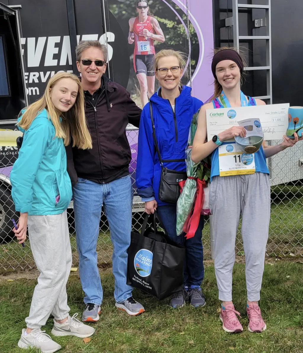 Lila Gaudrault poses with her family and awards.