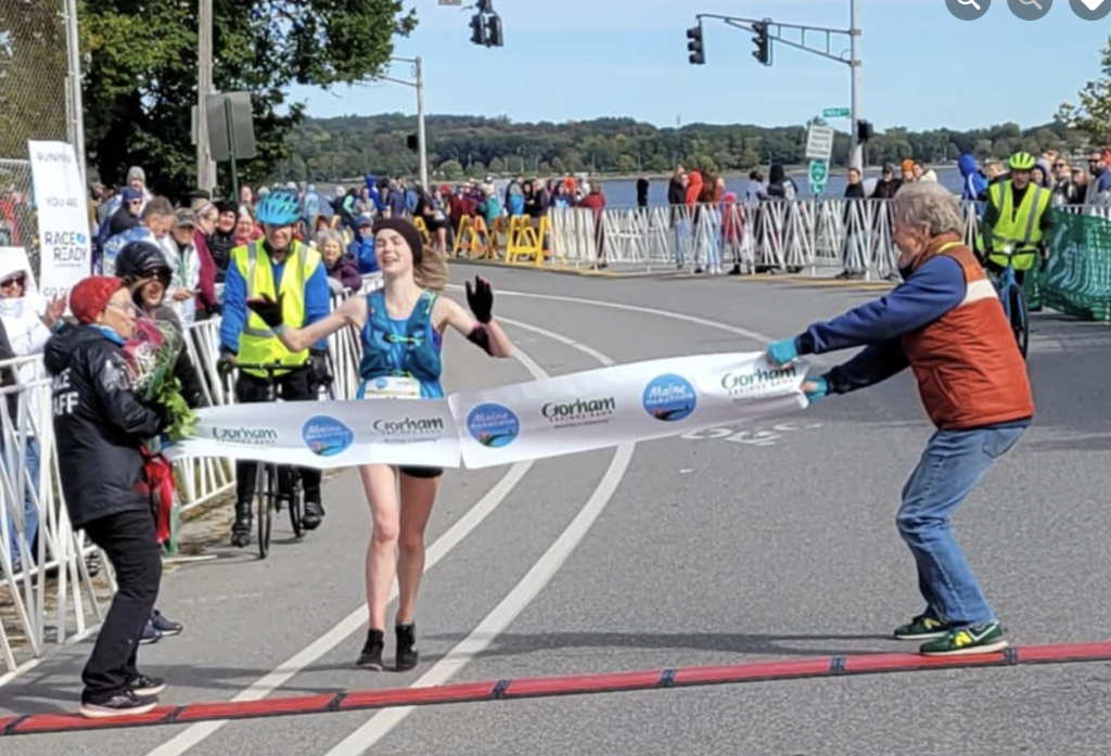 Nursing student Lila Gaudrault crosses the finish line at the Maine Marathon