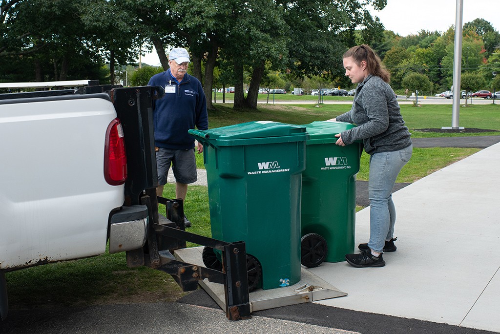 A U N E student assisting with waste management