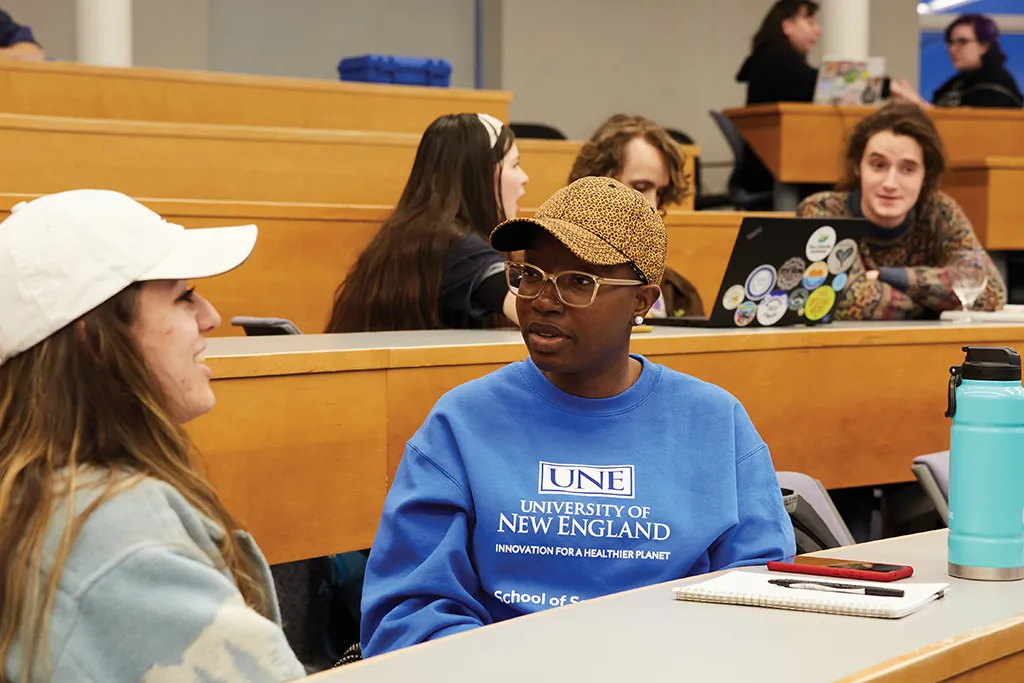Two U N E students discussing topics from the Climate and Justice Teach-in