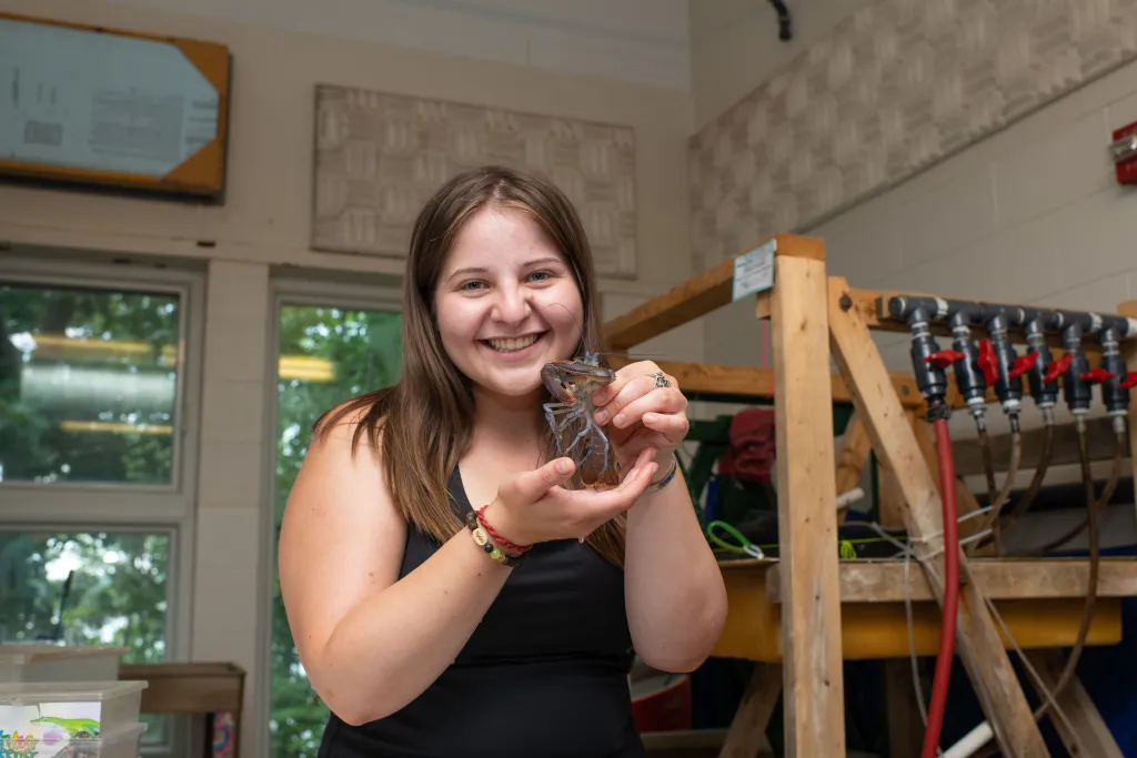 U N E student Aubrey Jane holds a crab