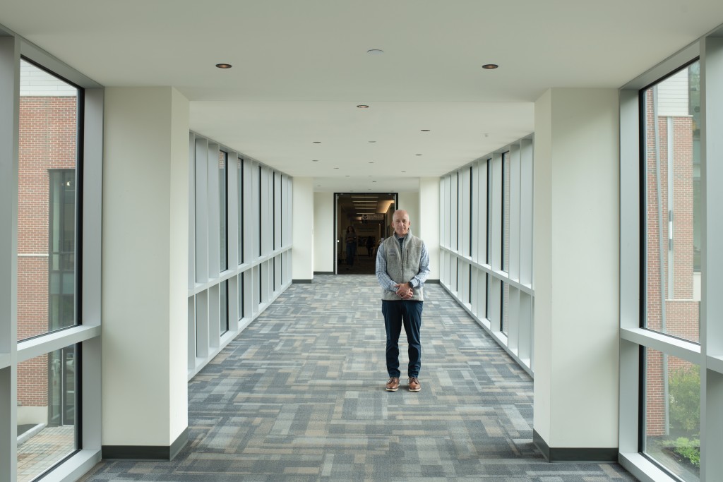 Portrait of Jonathan Millen standing in a hallway