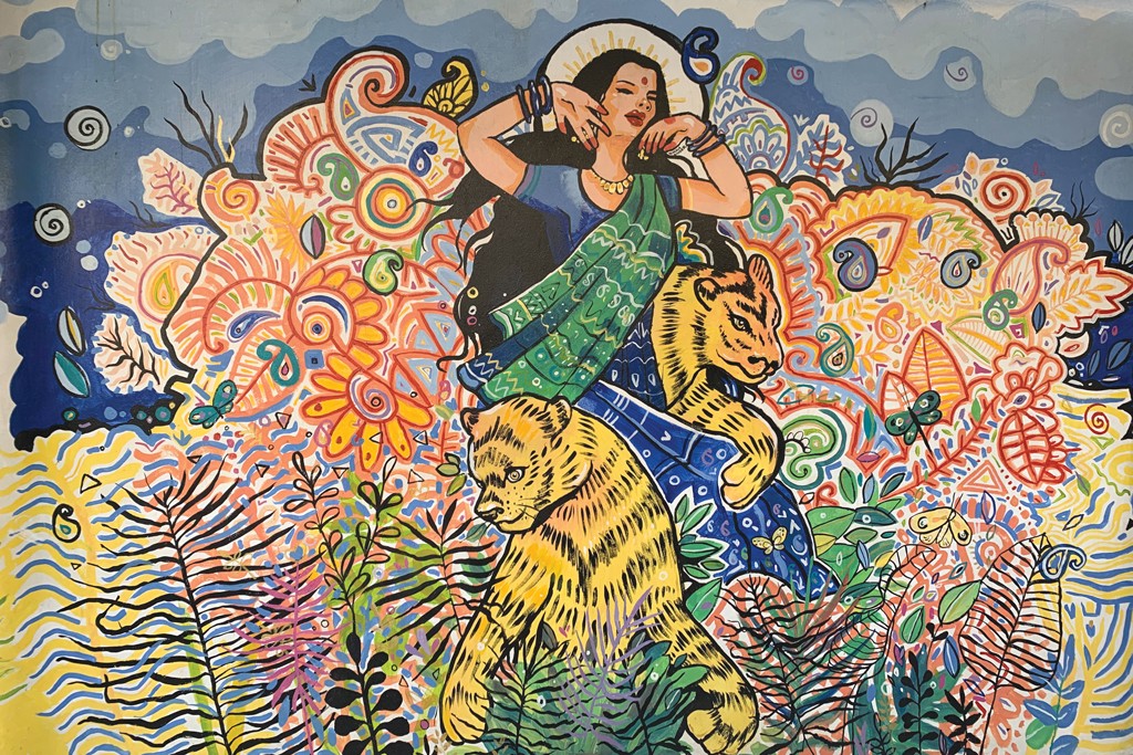 An abstract art mural of a woman and tiger amongst flowers