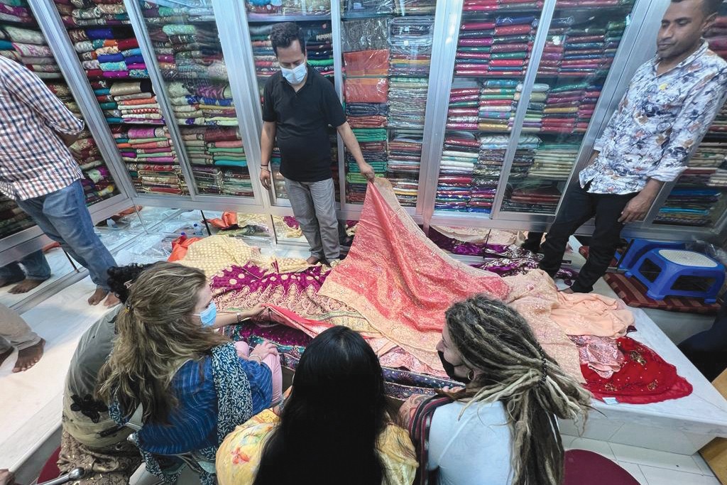 Woman looking at fabric for sarees