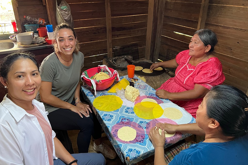 Four women making tortillas from scratch