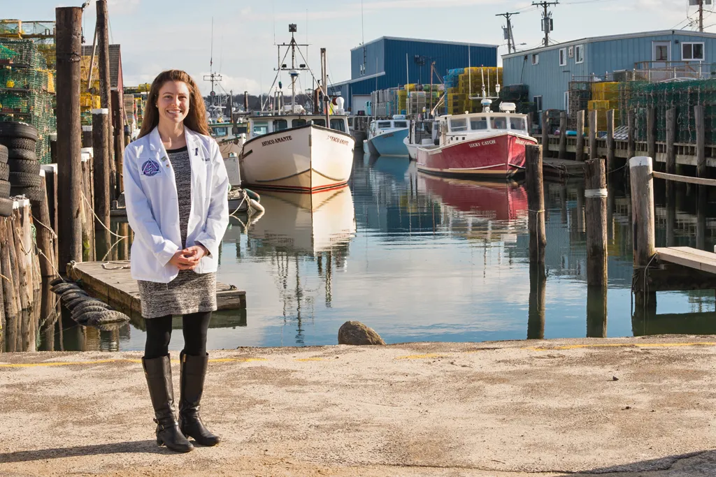 A dental student stands at Widgery Wharf in downtown Portland, Maine
