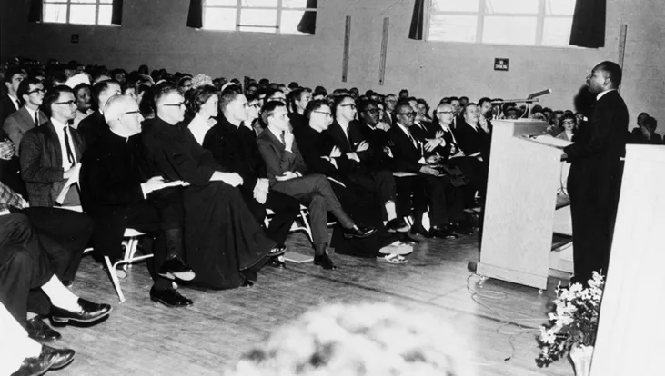 Dr. Martin Luther King Jr. speaks to an audience in 1964 at U N E’s precursor institution, St. Francis College