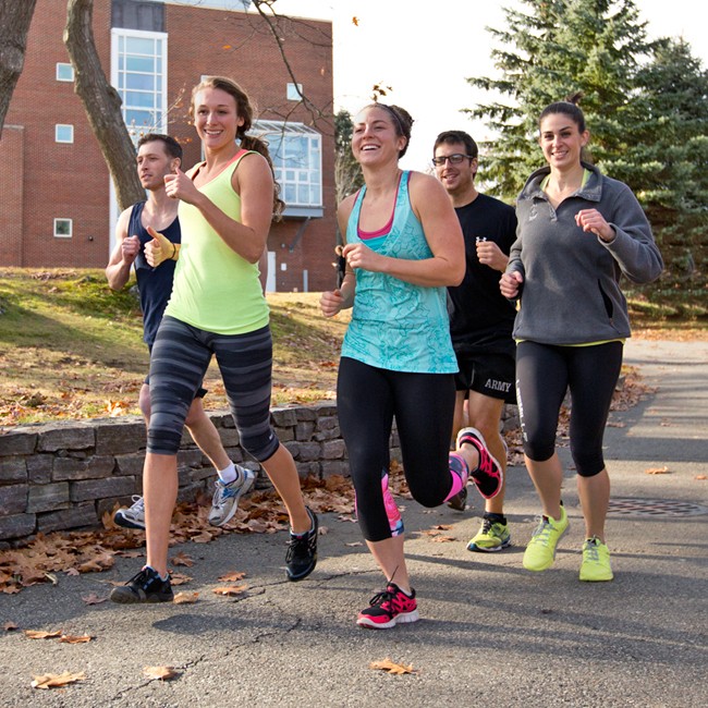 A group of students running together on the Biddeford Campus
