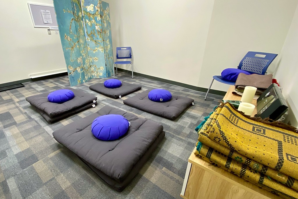 Interior shot of the Interfaith Prayer and Reflection Room including floor pillows and blankets