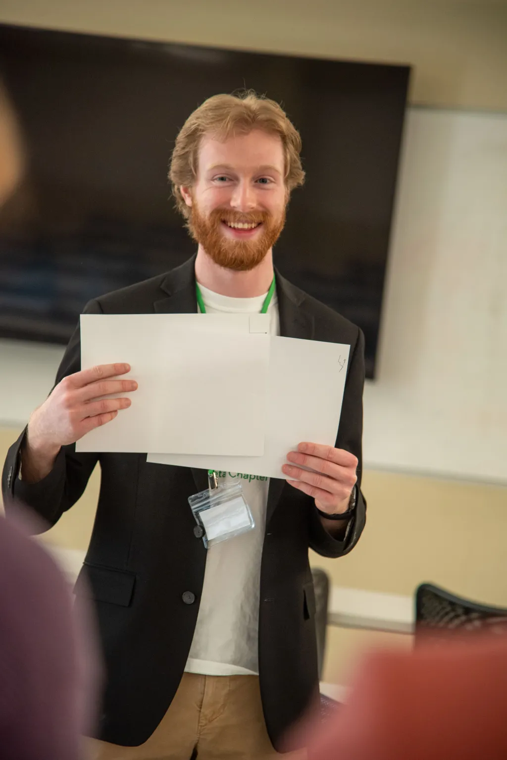 Ben Pastore holds up two drawings