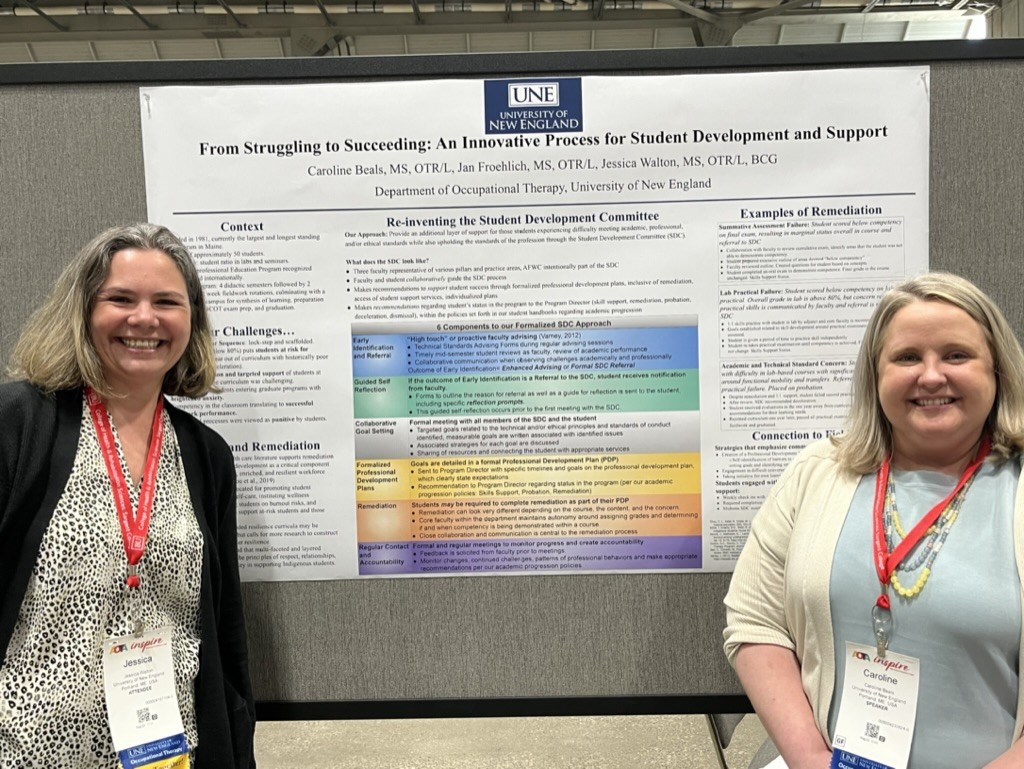 Walton and Beals pose in front of their research poster