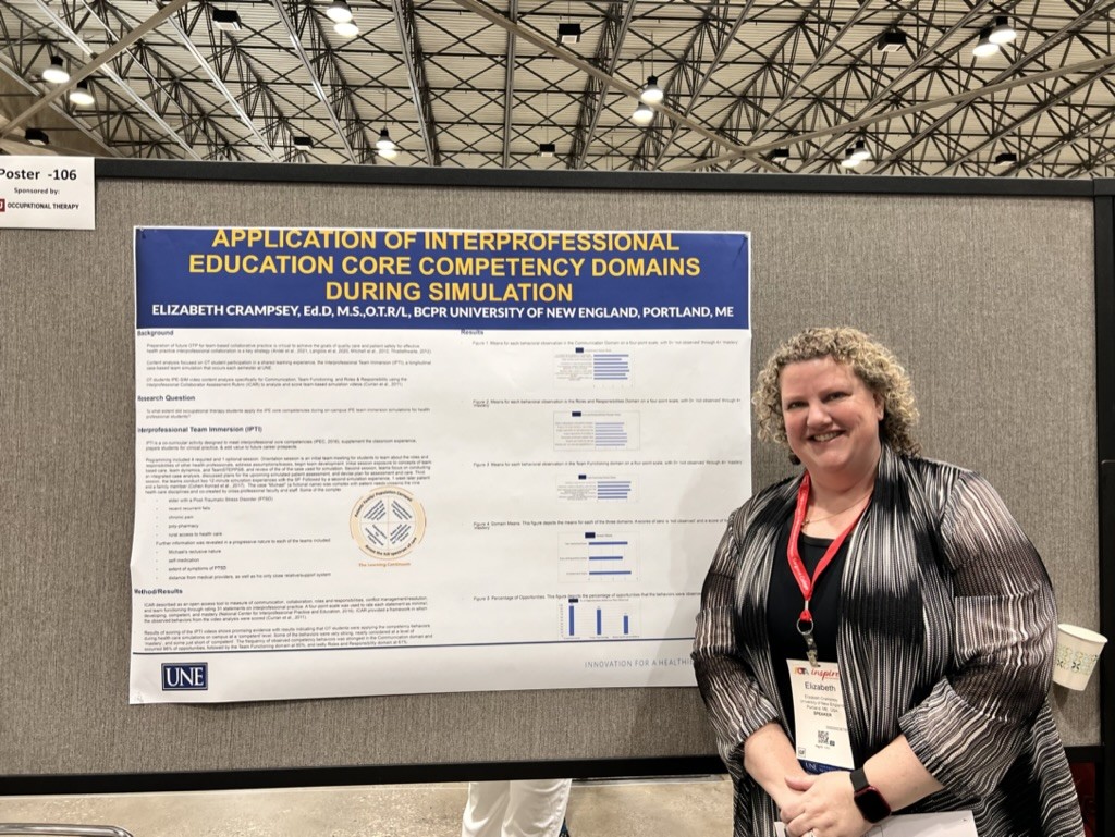 Elizabeth Crampsey poses in front of her research poster