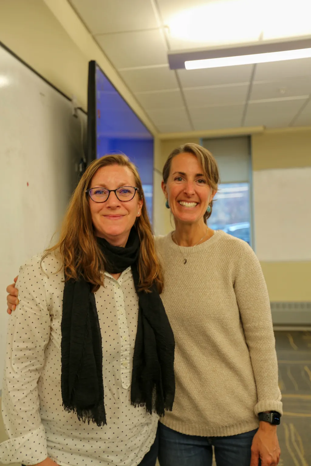 two women posting and smiling