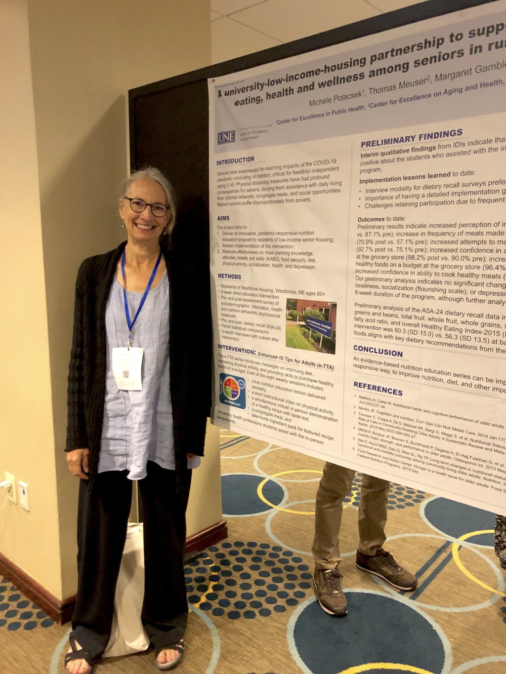 Michele Polacsek poses with her research poster