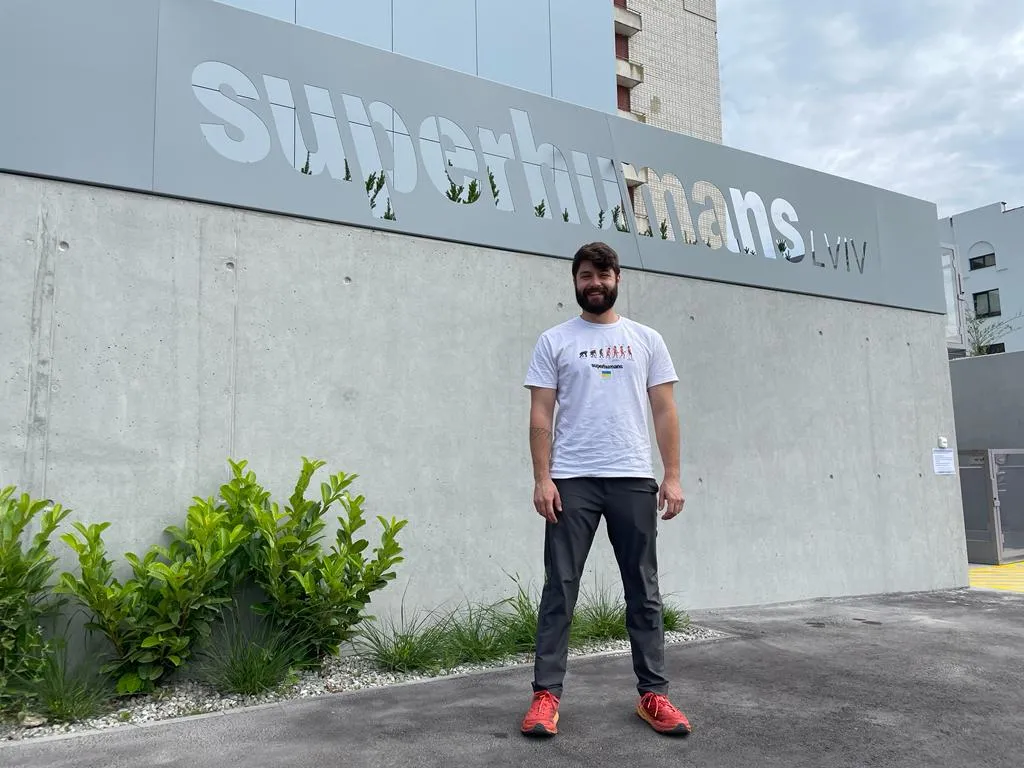 Motley poses in front of the Superhumans clinic in Lviv