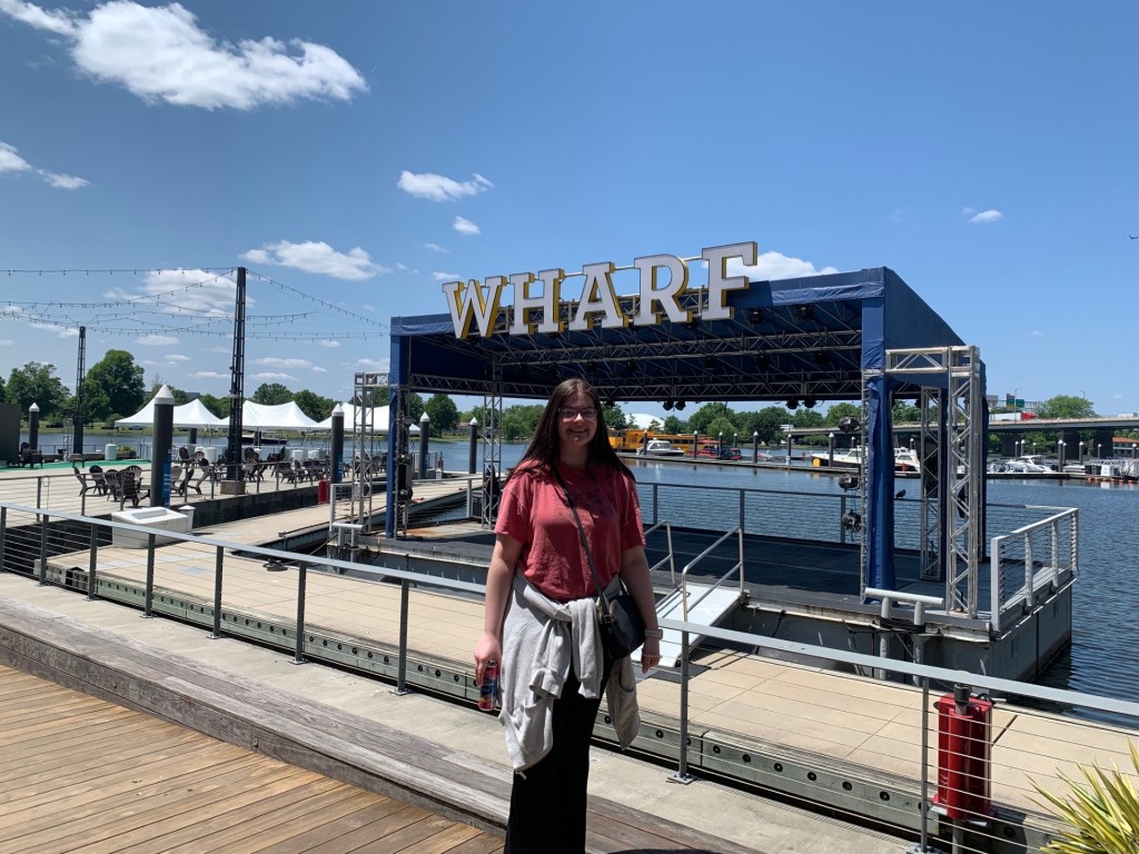 Sarah Gray poses in front of the Wharf in Washington, D.C.