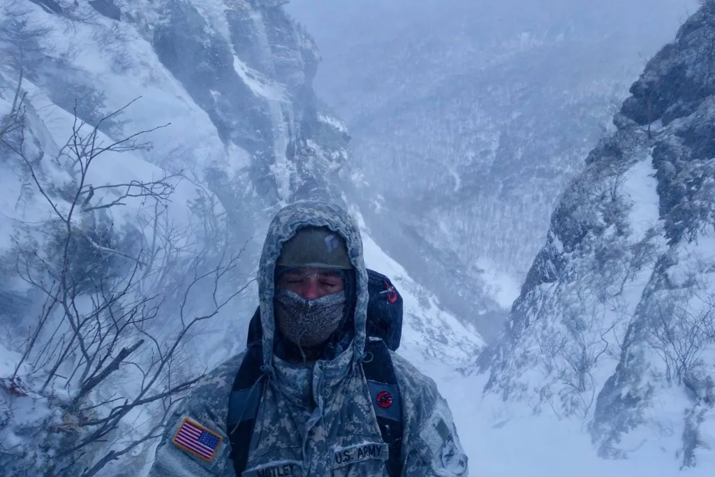 Motley stands in the harsh snow at Mountain Warfare School