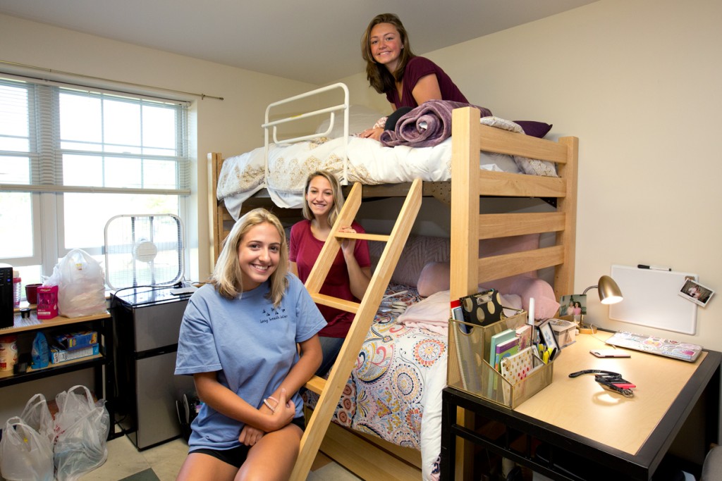 Three freshman hanging out in their new dorm room together