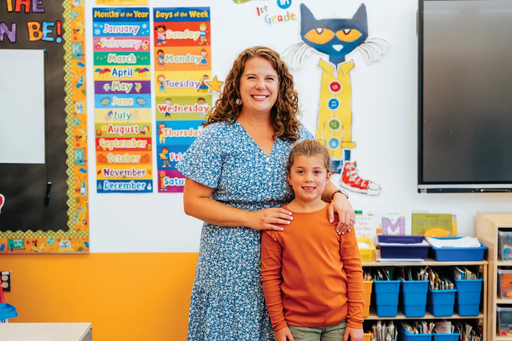 Emily Rosser stands with her daughter in her elementary school classroom