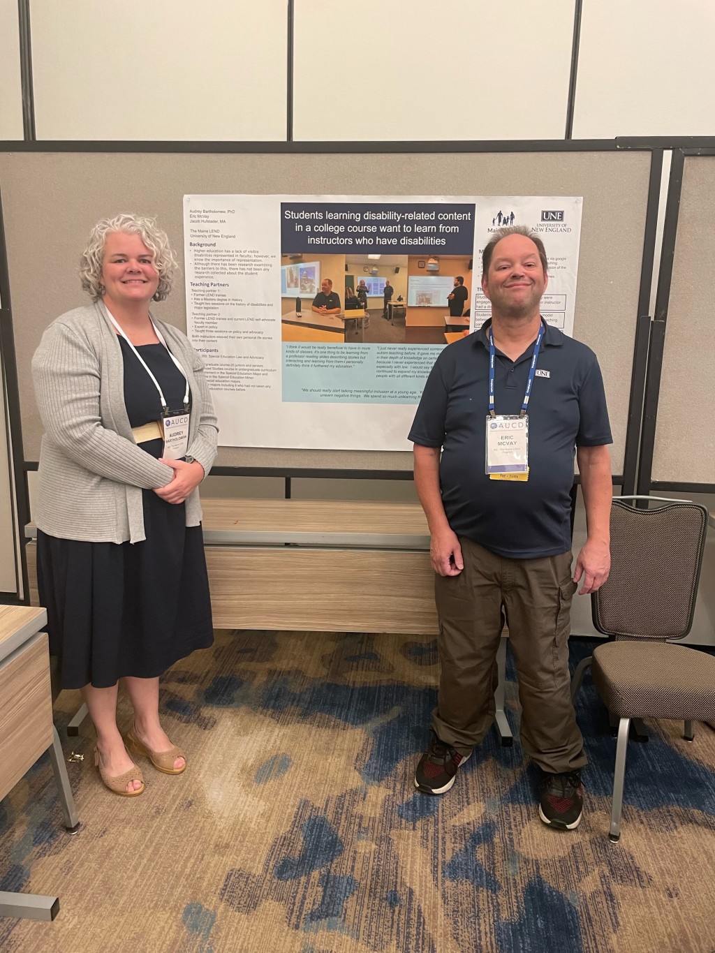 Audrey Bartholomew and Eric McVay pose in front of a research poster