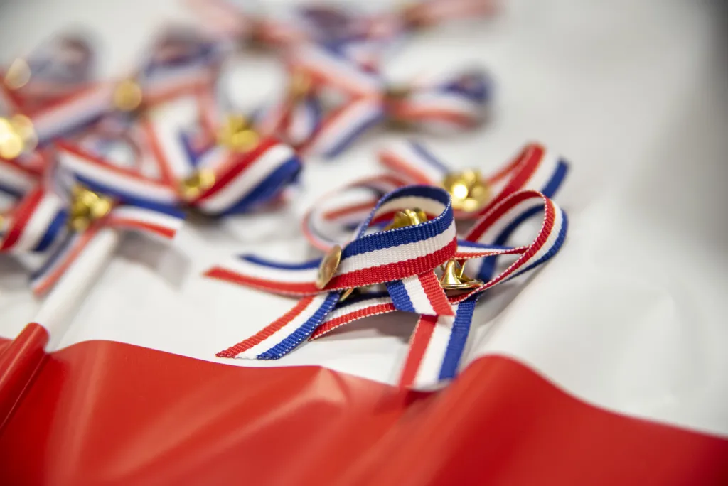 Red, white, and blue ribbons are laid out on a table
