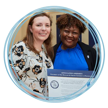 A representative from the U N E College of Osteopathic Medicine and from Cheyney University stand together at the Articulation Agreement Signing between both schools