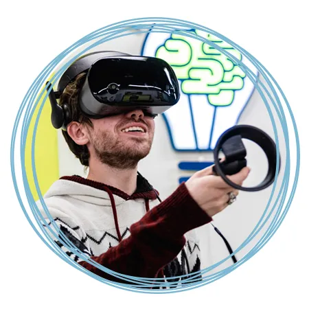 A student using a V R controller while wearing the headset