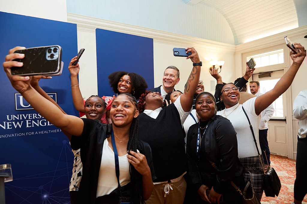 A group of Cheyney University students take a selfie with UNE President James Herbert 