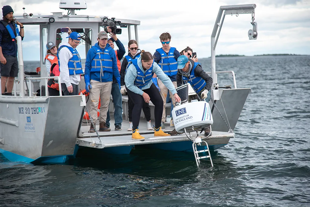 UNE students deploy a shark detection buoy from the RV Sakohki into Saco Bay