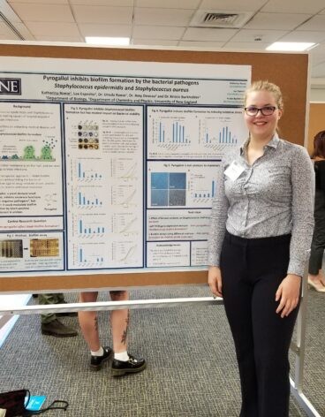 Katharina Roese poses in front of a research poster