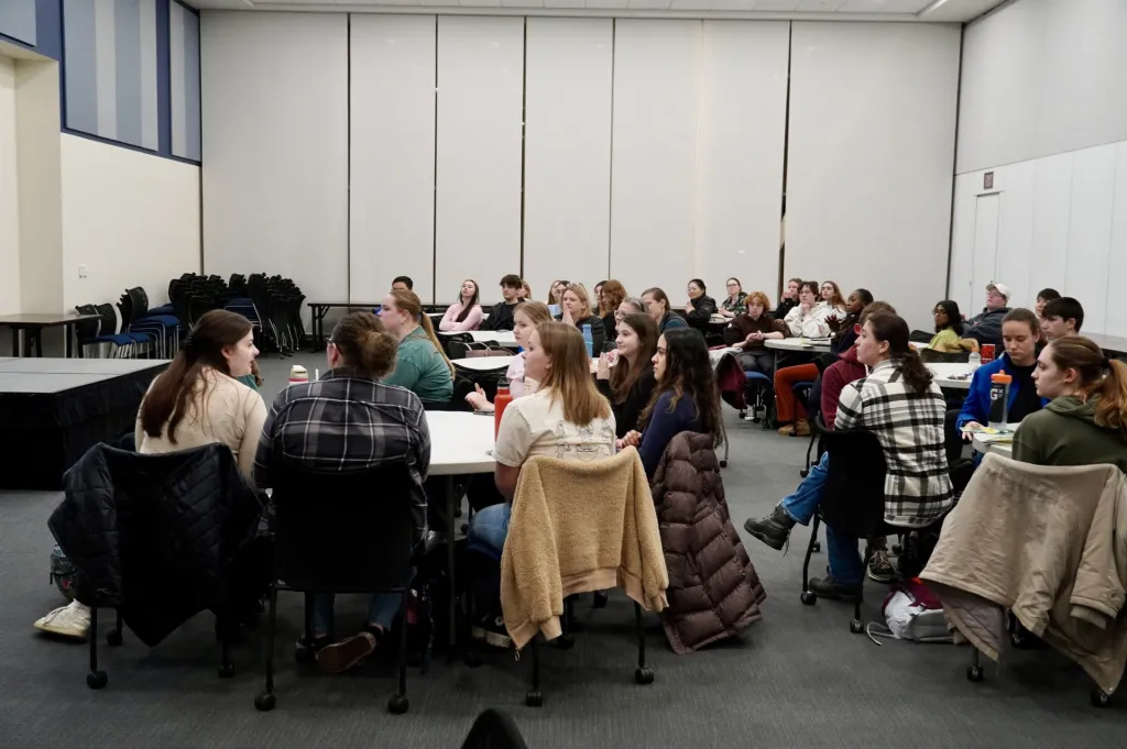 Students gather at tables