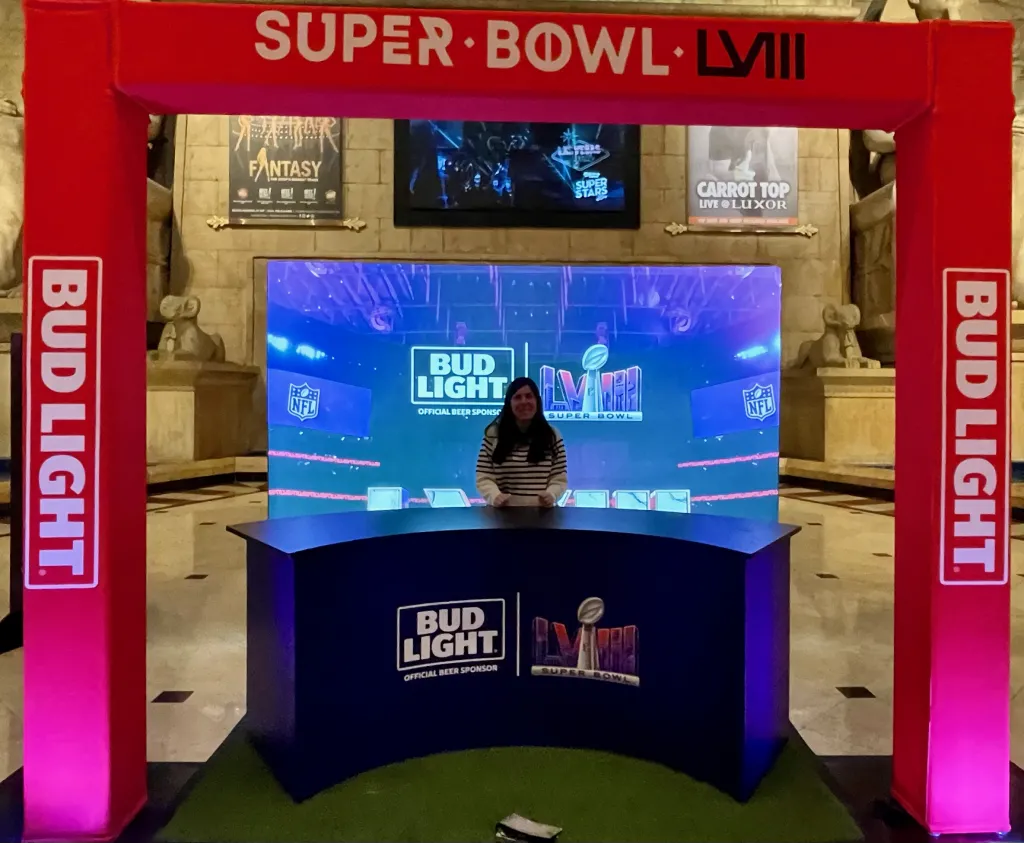A female professor poses at a sports commentator desk