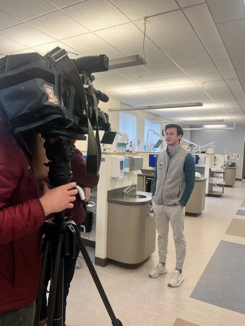A student speaks with news media