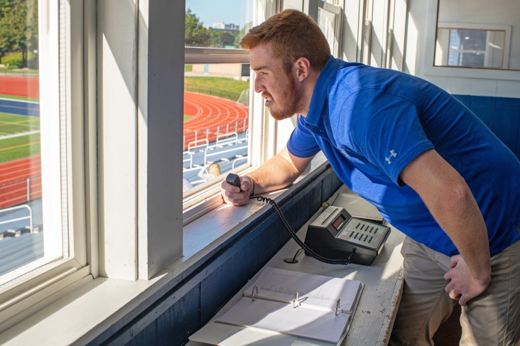 U N E student looks out over a track field