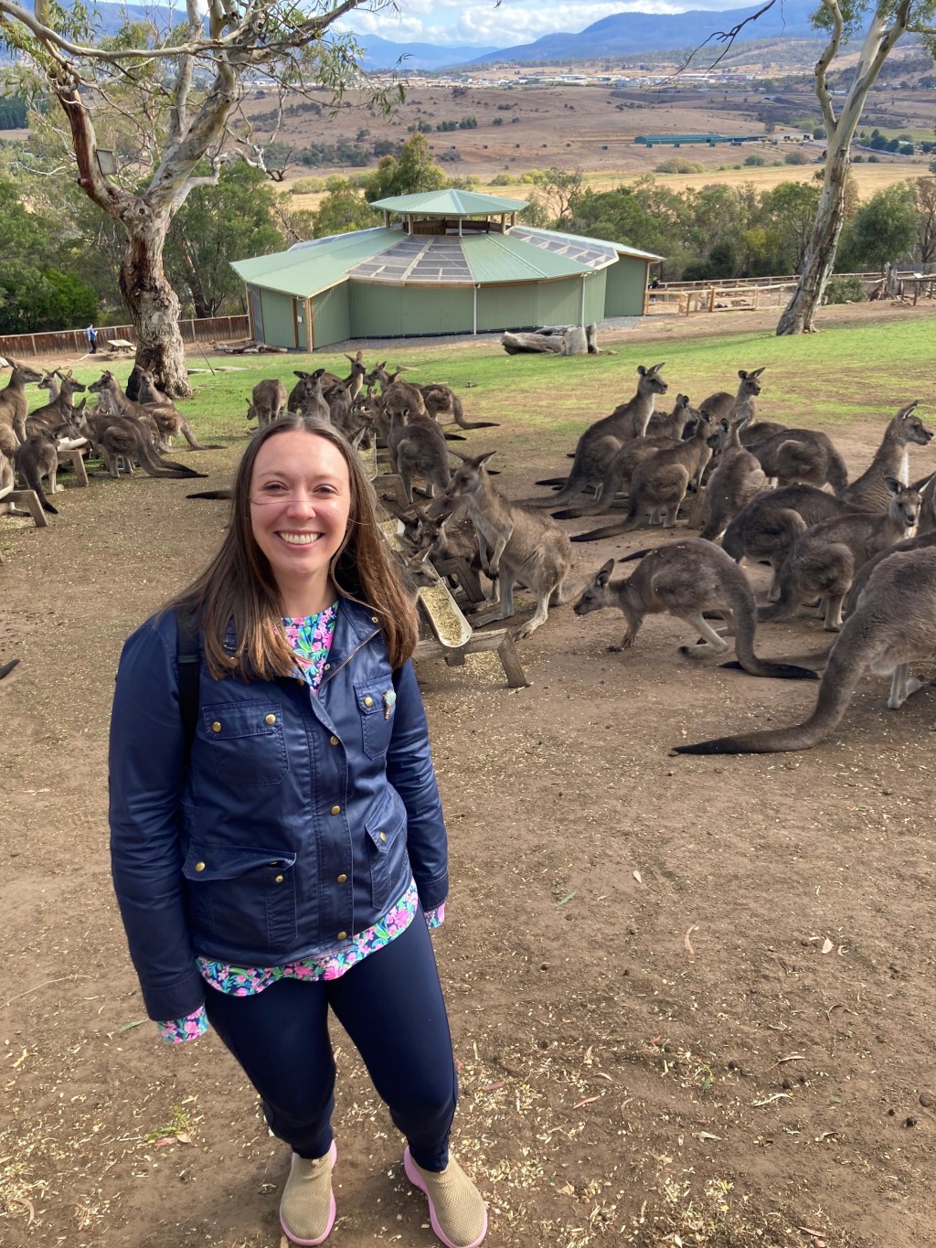 UNE professor Patricia Thibodeau poses with kangaroos in the background
